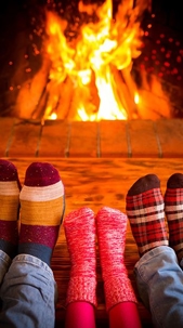 socked feet in front of fireplace