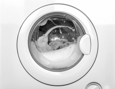 Front load washing machine with soap suds inside