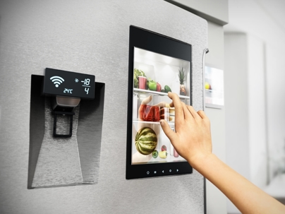 Homeowner using touchscreen monitor on their fridge