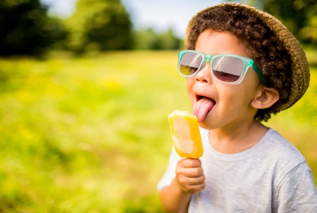 A kid eating ice cream on a summer day