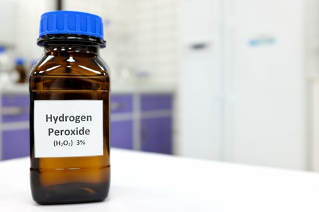 A bottle of hydrogen peroxide sitting on the counter