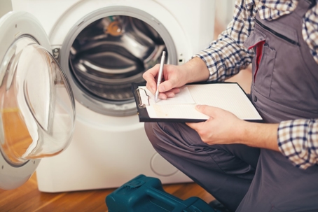 technician writing estimate for appliance repair