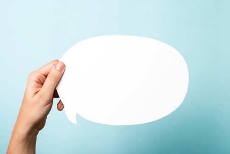 hand holding speech bubble