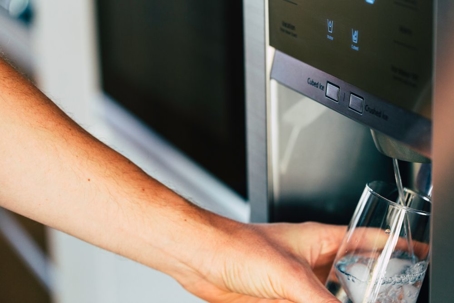 filling glass of water from fridge tap