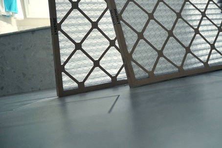 two-hvac-air-filters-leaning-against-wall