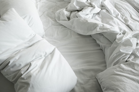 white-sheets-crumpled-up-on-bed