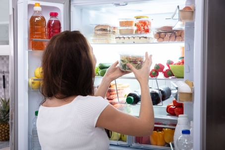 woman-getting-food-out-of-fridge