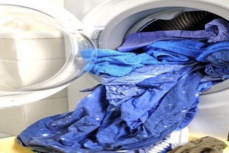 laundry spilling out of washing machine
