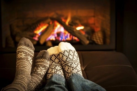 socked feet in front of fireplace