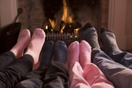 socked feet in front of fireplace