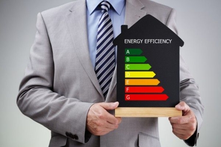 man holding energy efficiency chart