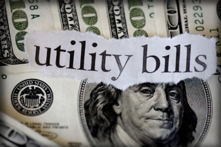 Utility bills written on a dollar