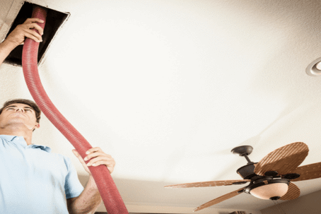 man cleaning air duct