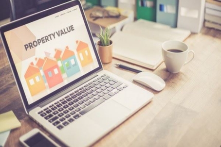 "property value" page open on laptop