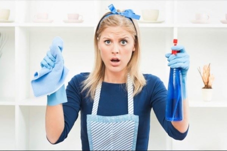 woman holding up cleaning products