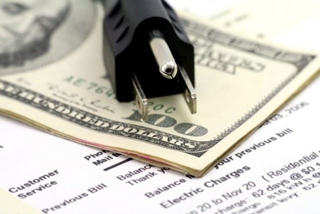 plug resting on $100 bills